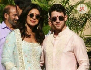Priyanka Chopra & Nick Jonas posing for media after finishing their wedding Pooja 